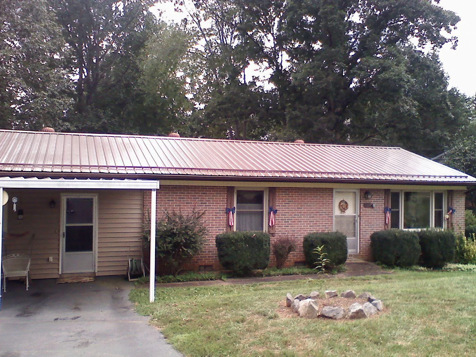 Bronze metal roof and carport on a brick ranch home in Joliet